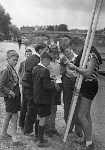June, 30 1954. American sculler and Olympic medal winner John B. Kelly, Jr. (1927 - 1985) takes a break from training for the Diamond Sculls for a group of autograph hunters. Courtesy of HRR - Click for full-size image!