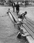 July 3, 1963 Rowers from Cornell University swim to the landing-stage after their boat capsizes after winning the 'Wyfold Fours' on the opening day of the Henley. Courtesy of HRR - Click for full-size image!