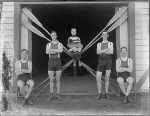 ca 1905-1926 Rowing fours team with coxswain holding rudder sitting on crossed paddles. Courtesy of the National Library of New Zealand. - Click for full-size image!